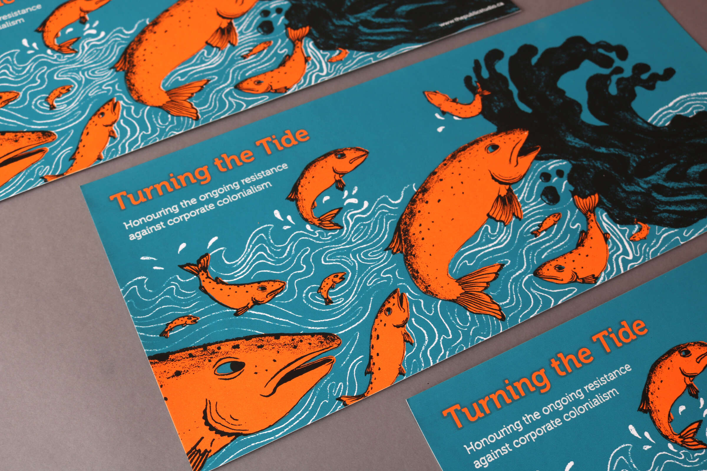 Illustrated posters featuring orange fish swimming against a teal blue backdrop with wavy lines. Text reads "Turning the Tide: Honoring the ongoing resistance against corporate colonialism." A person with long, flowing dark hair interacts with the fish.