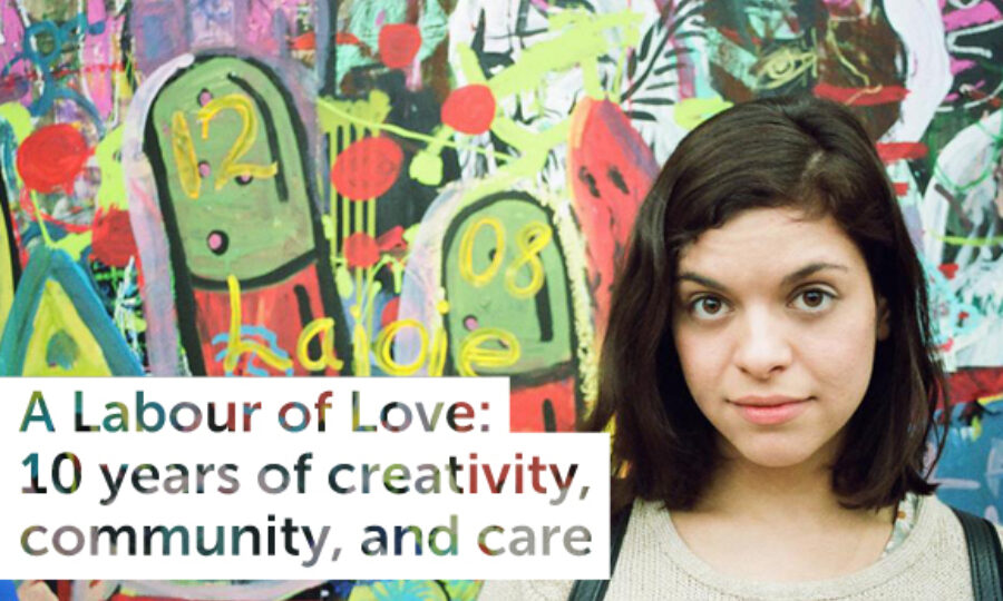 A woman with shoulder-length brown hair stands in front of a colorful, abstract mural. Text over the image reads: "A Labour of Love: 10 years of creativity, community, and care.