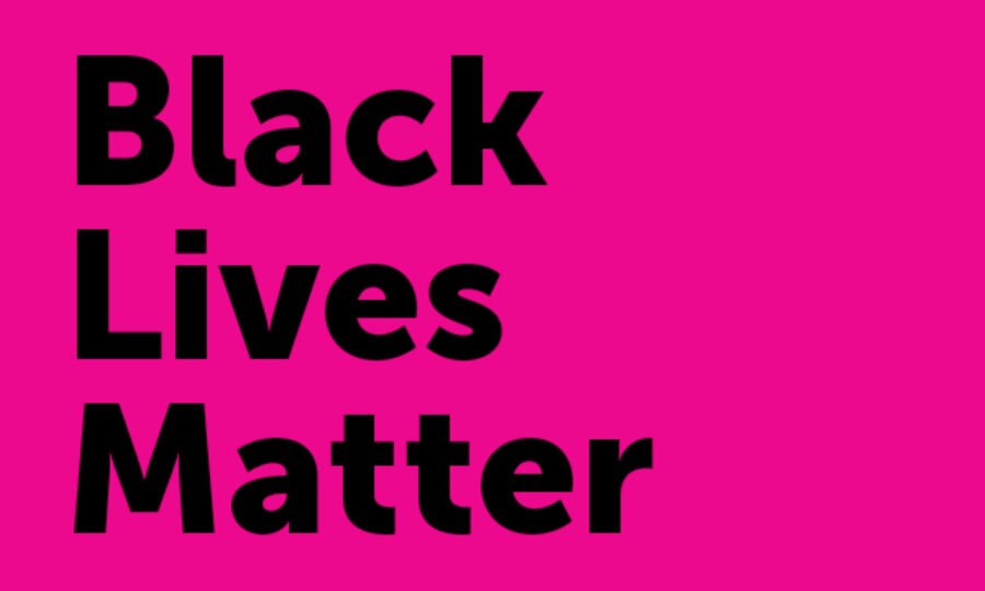 A bright pink background with the words "Black Lives Matter" written in bold, black letters. The text is aligned to the left.