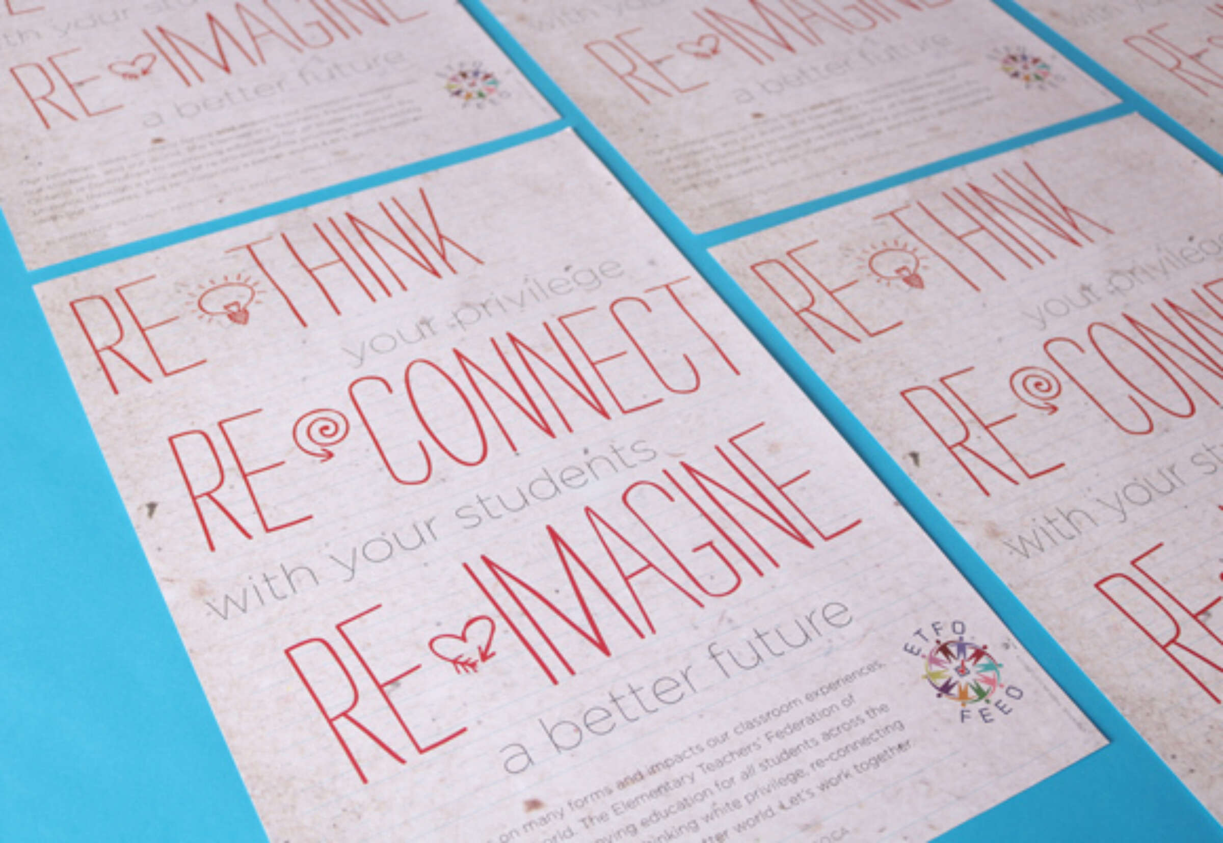 Flyers laying on a blue surface with the text "RE-IMAGINE a better future," "RE-THINK your privilege," "RE-CONNECT with your students," and "Rethink, Reconnect, Reimagine a better future" printed in red. EFO and FEB logos are present at the bottom.