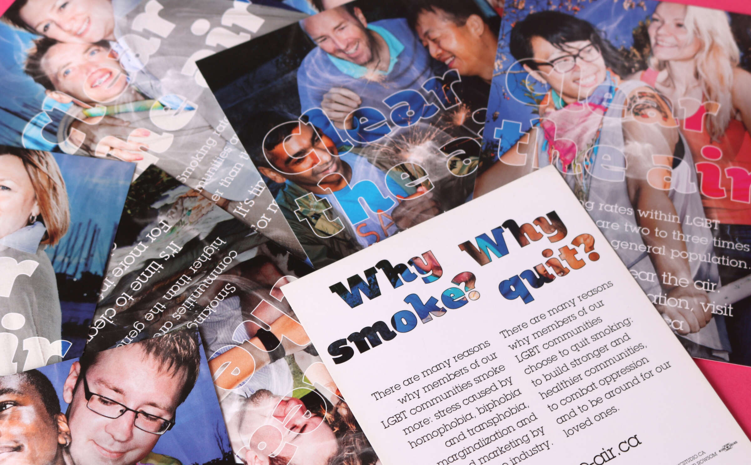 A close crop of the "Clear the Air" poster designs, with one flipped over to show the back of the design and the headline "Why smoke? Why quit?"