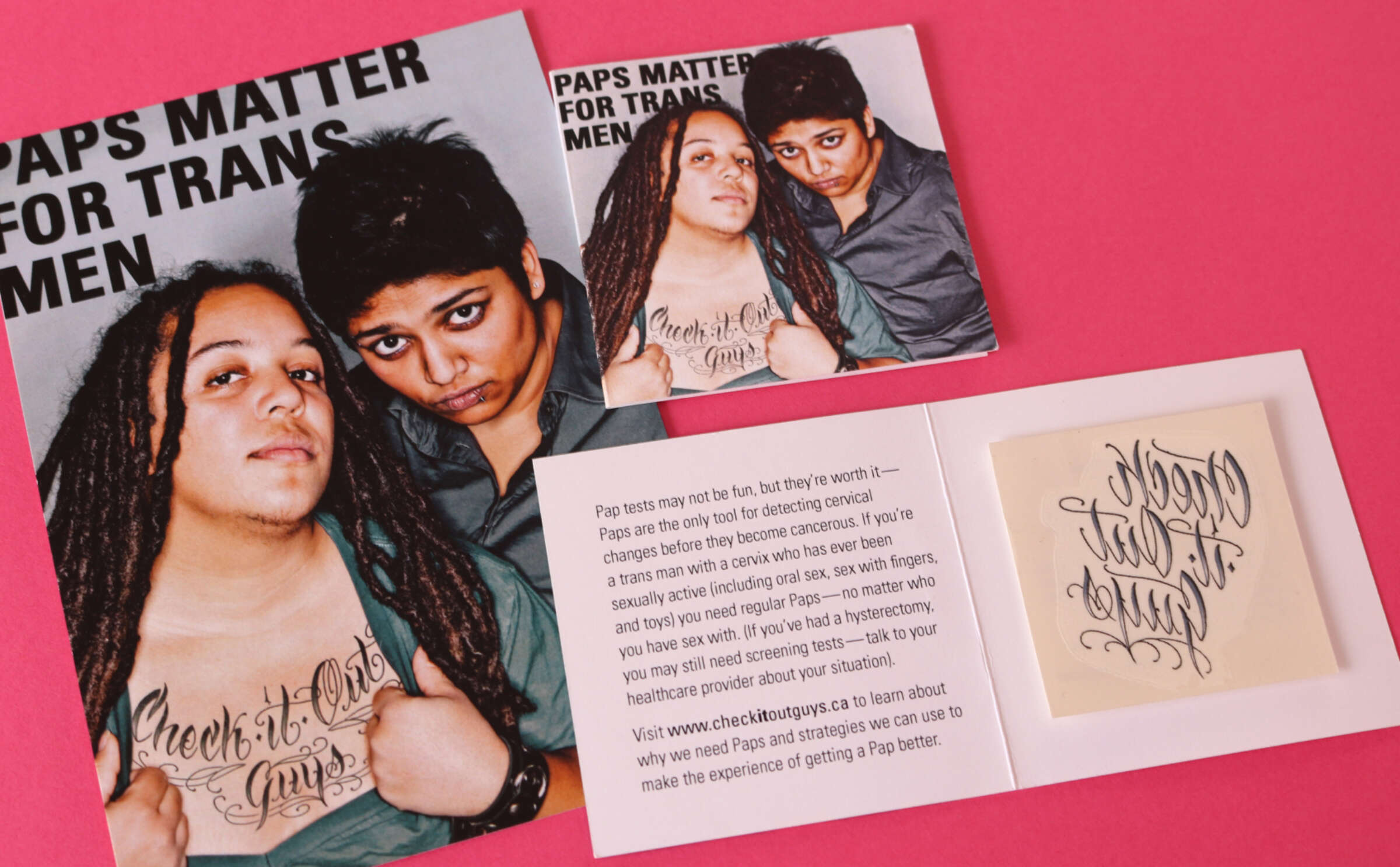 A pamphlet titled "Paps Matter for Trans Men" features two individuals with a tattoo reading "Check It Out Fellas." An inner page contains text explaining the importance of pap tests for trans men and includes a temporary tattoo. The background is pink.