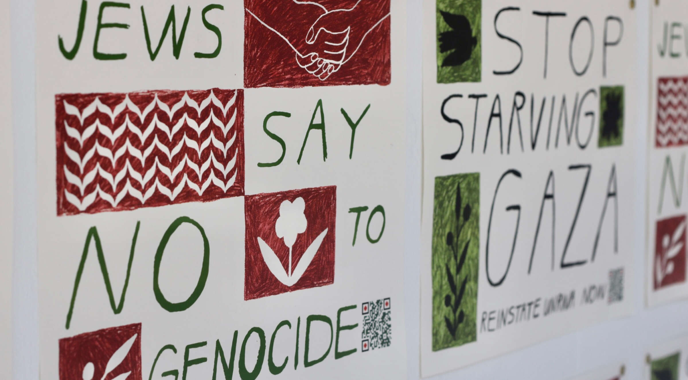 Image showing three poster-like messages. The first reads "JEWS SAY NO TO GENOCIDE" with some red and green illustrations, including a handshake and a flower. The second reads "STOP STARVING GAZA". Both posters have QR codes at the bottom.