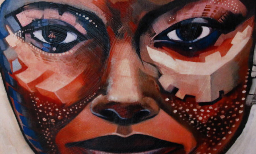 A close-up of an abstract painting depicting a human face. The face is composed of geometric shapes, varying in shades of red, brown, beige, and blue. The eyes are prominent, with expressive details, and the overall style is fragmented and textured.